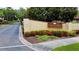 The entrance to Pinehurst Village with lush landscaping and clear signage at 1701 Pinehurst Rd # 33E, Dunedin, FL 34698