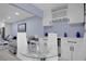 This dining area has a view of the living room, and features a glass table, a wine rack, and cabinets at 1701 Pinehurst Rd # 33E, Dunedin, FL 34698