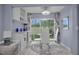 Chic dining area featuring modern furnishings and a view of the beautifully landscaped backyard at 1701 Pinehurst Rd # 33E, Dunedin, FL 34698