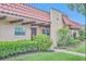 Charming single-story home with a red tile roof, covered entry, and manicured landscaping at 1701 Pinehurst Rd # 33E, Dunedin, FL 34698