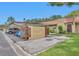 The property features covered parking adjacent to the front of the house with a charming terracotta tile roof at 1701 Pinehurst Rd # 33E, Dunedin, FL 34698