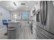 Modern kitchen featuring marble countertops, white cabinets, and stainless steel appliances at 1701 Pinehurst Rd # 33E, Dunedin, FL 34698