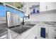 Bright kitchen featuring a stainless sink, black faucet and sleek countertop with a drying rack insert at 1701 Pinehurst Rd # 33E, Dunedin, FL 34698