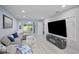 Living room showcasing a large television, modern fireplace, and comfortable seating at 1701 Pinehurst Rd # 33E, Dunedin, FL 34698