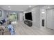 Bright living room with modern decor, featuring a large television and sliding glass doors at 1701 Pinehurst Rd # 33E, Dunedin, FL 34698