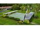 Aerial view of shuffleboard courts surrounded by lush landscaping and covered seating areas at 1701 Pinehurst Rd # 33E, Dunedin, FL 34698