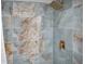 Modern shower featuring sleek blue marble-look tiling and gold fixtures at 1701 Pinehurst Rd # 33E, Dunedin, FL 34698