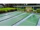 View of the community shuffleboard court with shaded benches for players at 1701 Pinehurst Rd # 33E, Dunedin, FL 34698