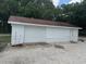 Detached garage with ample storage space and a convenient roll-up door at 17048 State Road 54, Lutz, FL 33558