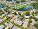Aerial view showcases a community with beautiful lakes and surrounding lush greenery at 1717 Atrium Dr, Sun City Center, FL 33573