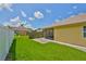 Private backyard featuring a well-maintained lawn and partial fencing at 1717 Atrium Dr, Sun City Center, FL 33573