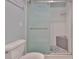 Bathroom featuring a walk-in shower with decorative tiling and a glass door at 1717 Atrium Dr, Sun City Center, FL 33573