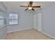 Bedroom with neutral carpet, ceiling fan, and closet at 1717 Atrium Dr, Sun City Center, FL 33573