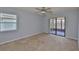 Bedroom featuring neutral carpet and sliding glass doors at 1717 Atrium Dr, Sun City Center, FL 33573