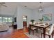 Inviting dining area with a modern light fixture, stylish table setting, and hardwood floors at 1717 Atrium Dr, Sun City Center, FL 33573