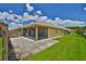 Exterior backyard view with a well-kept lawn and enclosed screened in lanai at 1717 Atrium Dr, Sun City Center, FL 33573