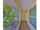 Inviting screened-in front entrance with a lush palm tree, leading to the front door at 1717 Atrium Dr, Sun City Center, FL 33573