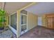 Charming screened-in front entrance with a side door and a wooden front door for easy access at 1717 Atrium Dr, Sun City Center, FL 33573