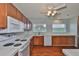 Functional kitchen featuring a white oven, wood cabinets, laminate countertops, and ample counter space at 1717 Atrium Dr, Sun City Center, FL 33573