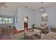 Bright living room with natural light, a dining area, and a view into the kitchen for easy living at 1717 Atrium Dr, Sun City Center, FL 33573
