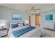 Serene bedroom featuring a king-size bed with blue accents and plenty of natural light at 1717 Atrium Dr, Sun City Center, FL 33573