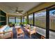 Enclosed patio with comfortable seating, offering a relaxing view of the backyard at 1717 Atrium Dr, Sun City Center, FL 33573
