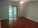 Bedroom featuring wood floors and sliding glass doors leading to the patio at 1813 Laurel Oak Dr, Valrico, FL 33596
