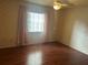 Bedroom featuring wood floors, wallpaper, a ceiling fan, and a window for natural light at 1813 Laurel Oak Dr, Valrico, FL 33596