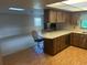 View of the kitchen leading to the living room featuring light colored counters and wood cabinetry at 1813 Laurel Oak Dr, Valrico, FL 33596