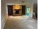 Living room with a stone fireplace, built-in shelves, and a sliding glass door to the backyard at 1813 Laurel Oak Dr, Valrico, FL 33596