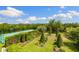 Landscaped backyard with a tennis court, lush lawn and beautiful landscaping at 18521 Wayne Rd, Odessa, FL 33556