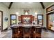 Wet bar with granite countertop, custom cabinetry, and seating for entertaining at 18521 Wayne Rd, Odessa, FL 33556