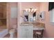 Pink bathroom featuring a vanity with a seated makeup area at 18521 Wayne Rd, Odessa, FL 33556