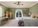 Bright primary bedroom featuring a desk, french doors, and a decorative screen at 18521 Wayne Rd, Odessa, FL 33556