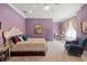 This bedroom is light and airy with a sitting area and a large, comfy bed at 18521 Wayne Rd, Odessa, FL 33556