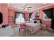 Bright bedroom with pink walls, window seat, and patterned bedding at 18521 Wayne Rd, Odessa, FL 33556