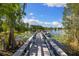 Lakeside dock with stunning water views and serene natural surroundings at 18521 Wayne Rd, Odessa, FL 33556