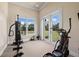 Home gym with workout equipment and views of the manicured outdoors at 18521 Wayne Rd, Odessa, FL 33556