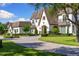 Charming front exterior of a two-story home featuring a fountain, lush lawn, and elegant architectural details at 18521 Wayne Rd, Odessa, FL 33556