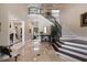 Grand foyer featuring marble floors, a staircase with iron railings, and elegant decor at 18521 Wayne Rd, Odessa, FL 33556