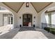 Elegant front entrance with double doors, travertine flooring, stone accents and tasteful landscaping at 18521 Wayne Rd, Odessa, FL 33556