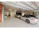 Oversized garage with epoxy flooring, providing ample space for multiple luxury vehicles and storage at 18521 Wayne Rd, Odessa, FL 33556