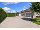 Spacious three-car garage with a paved driveway and manicured greenery, offering ample parking space at 18521 Wayne Rd, Odessa, FL 33556