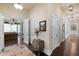 An elegant hallway features a wood floor, white trim, a decorative rug, and a view into the living room at 18521 Wayne Rd, Odessa, FL 33556