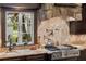 Updated kitchen has a stone backsplash, granite countertops, and gas cooktop at 18521 Wayne Rd, Odessa, FL 33556
