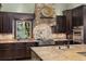 Chef's kitchen features granite countertops, gas range, and custom cabinets at 18521 Wayne Rd, Odessa, FL 33556