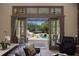 Comfortable living room with a leather sofa overlooking a pool area at 18521 Wayne Rd, Odessa, FL 33556