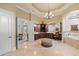 Luxury bathroom with dual vanities, a chandelier, and a soaking tub at 18521 Wayne Rd, Odessa, FL 33556