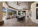 An outdoor kitchen and dining area overlooks the screened-in pool and waterfall feature at 18521 Wayne Rd, Odessa, FL 33556