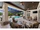 The covered outdoor living area features a fireplace and seating, with a pool view at 18521 Wayne Rd, Odessa, FL 33556